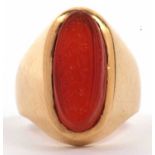 High grade yellow metal and carnelian set ring, the elongated oval shaped carnelian carved with