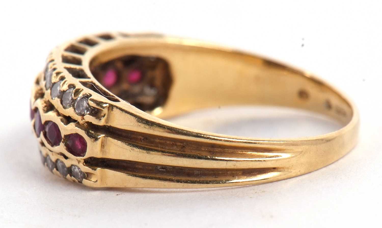 An 18ct ruby and diamond ring, the central row of round rubies, set above and below with a row of - Image 2 of 8
