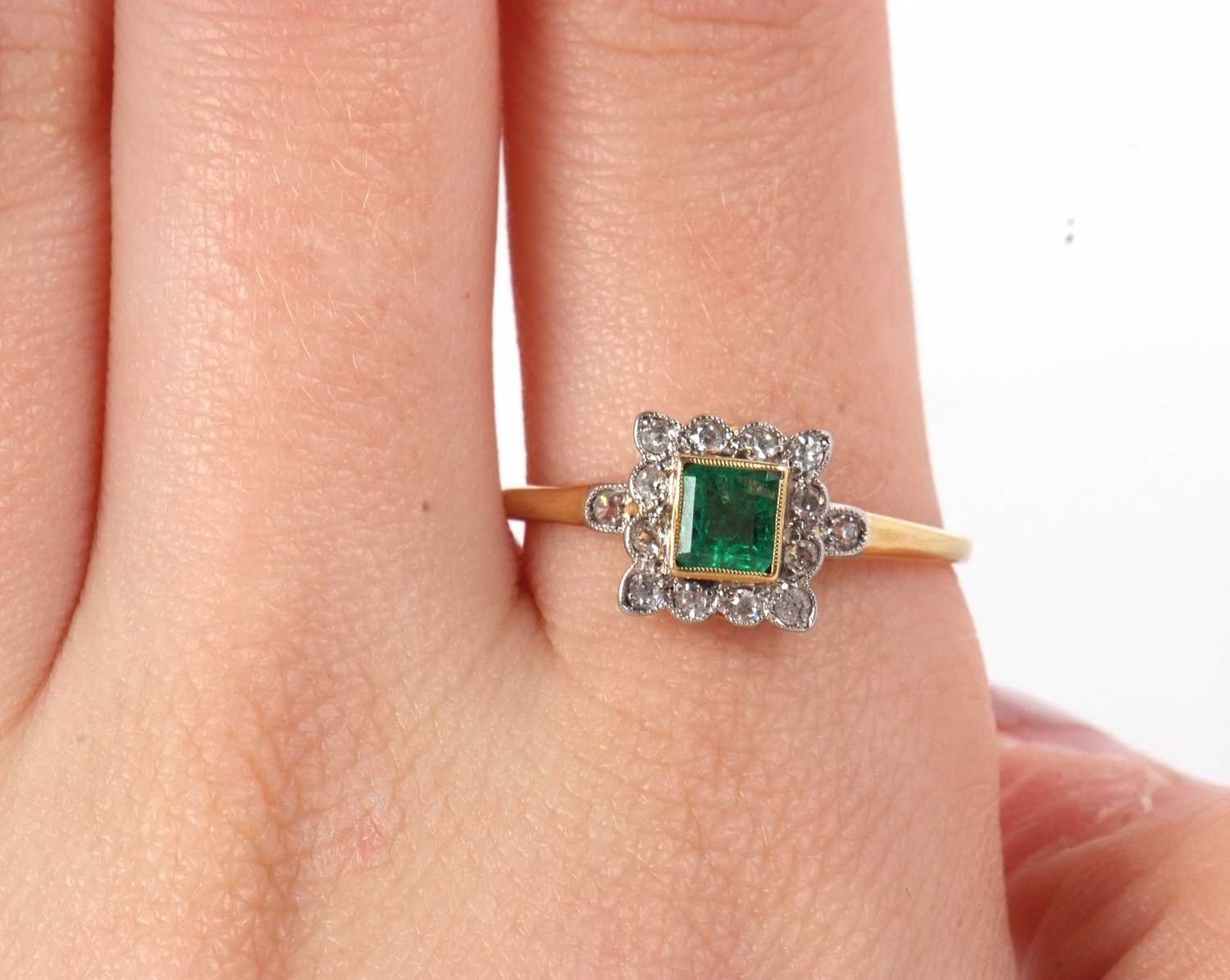 An emerald and diamond ring, the square step cut emerald, collet mounted with a surround of single - Image 10 of 11