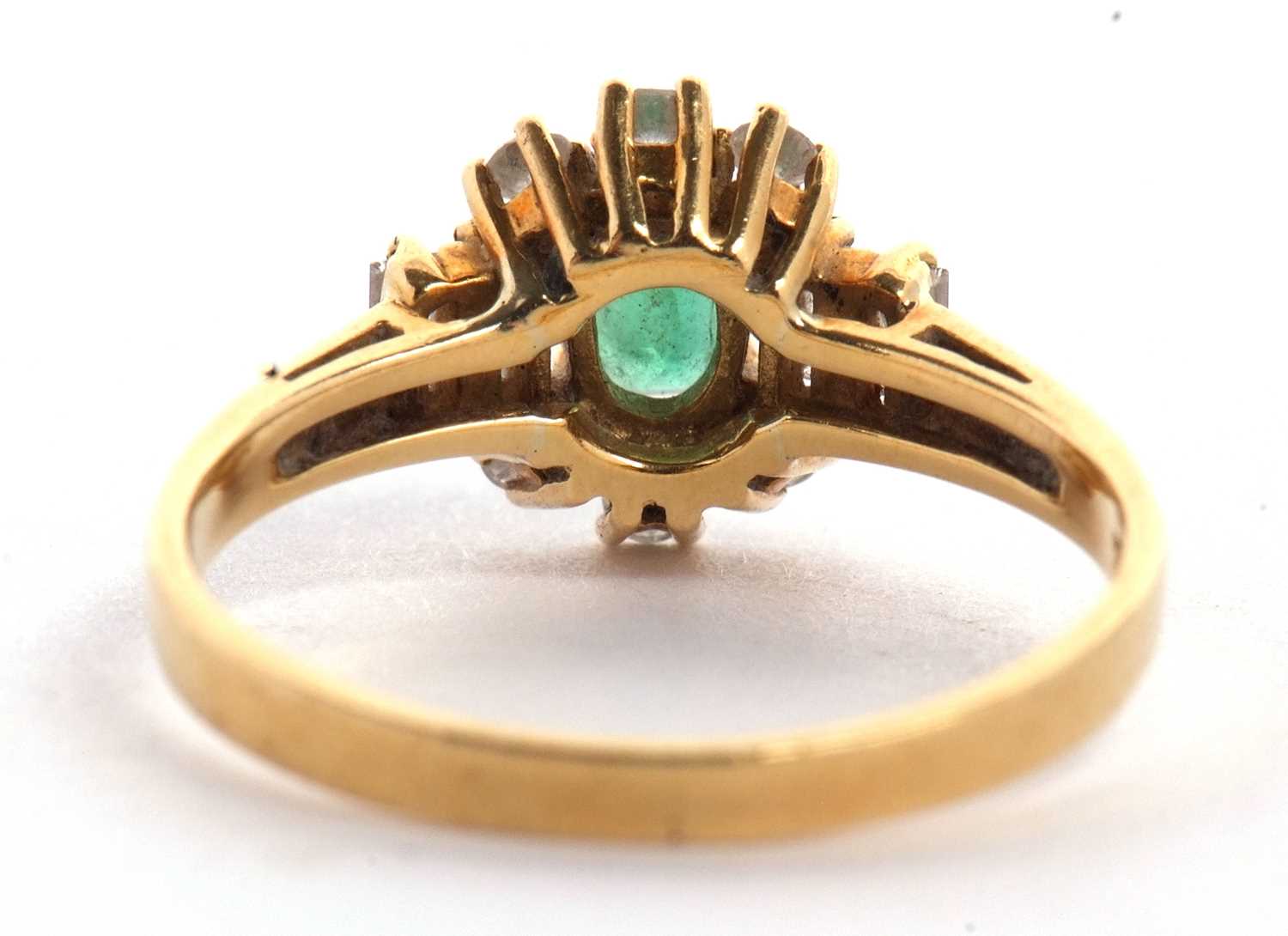An 18ct emerald and diamond ring, the central oval emerald set with three small round diamonds above - Image 12 of 16