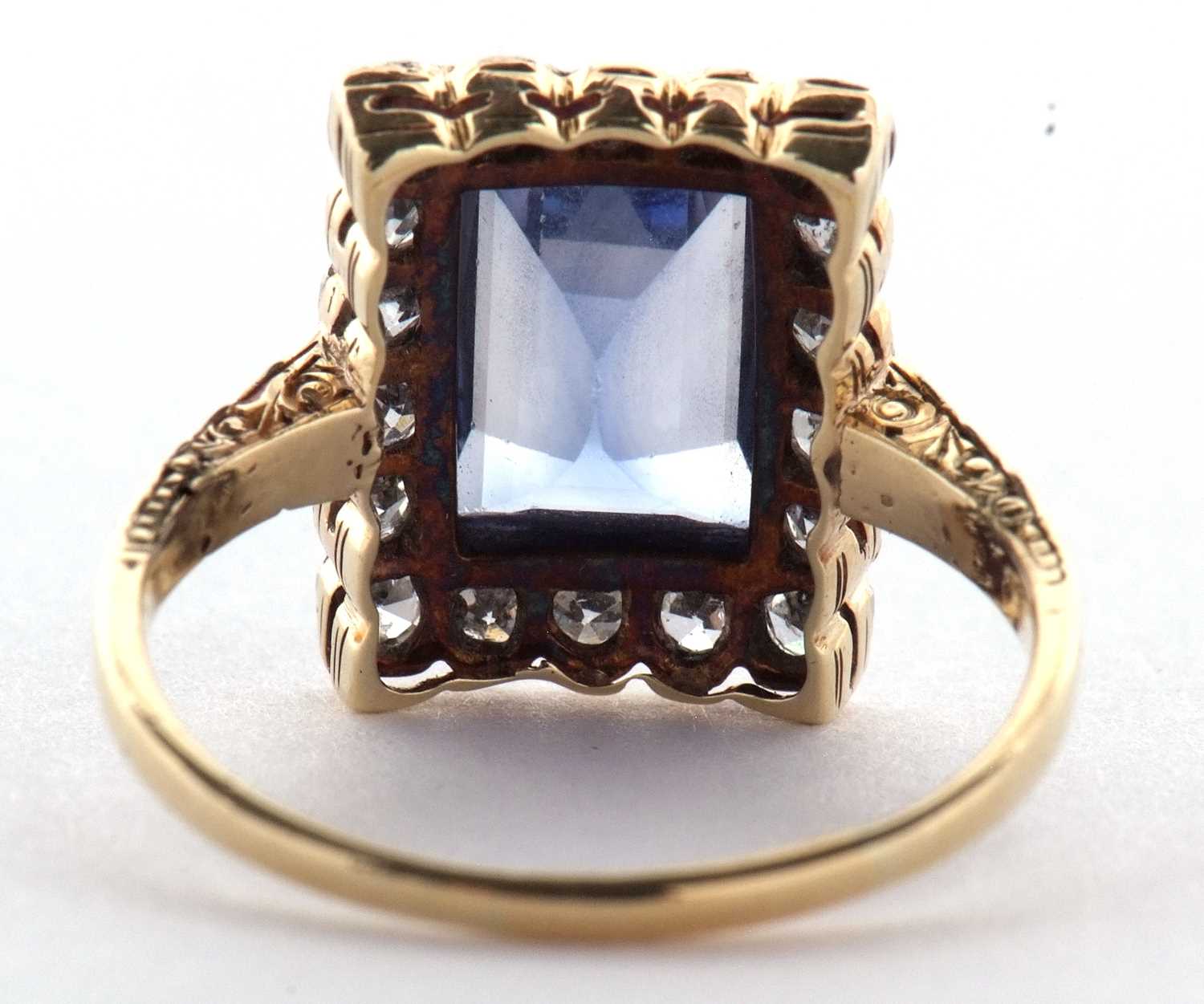 A sapphire and diamond ring, the radiant cut sapphire, approx. 9.9 x 6.9 x 4.9mm, surrounded by - Image 4 of 8