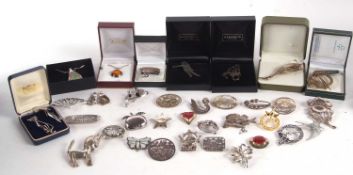 A quantity of silver and white metal brooches, all cased