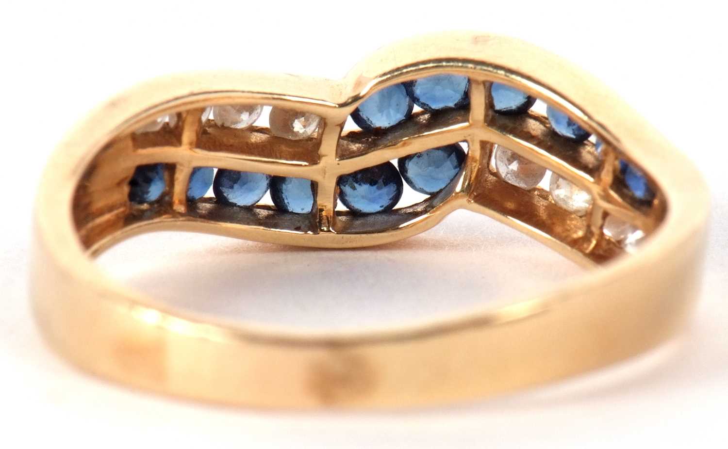 A 14ct sapphire and diamond ring, the two strand crossover style ring set with small round sapphires - Image 4 of 9