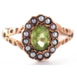 A 9ct peridot and seed pearl ring, the oval peridot surrounded by seed pearls, with split