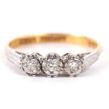 An 18ct and platinum diamond ring, the three round diamonds, illusion set to with engraved shoulders