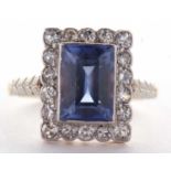 A sapphire and diamond ring, the radiant cut sapphire, approx. 9.9 x 6.9 x 4.9mm, surrounded by