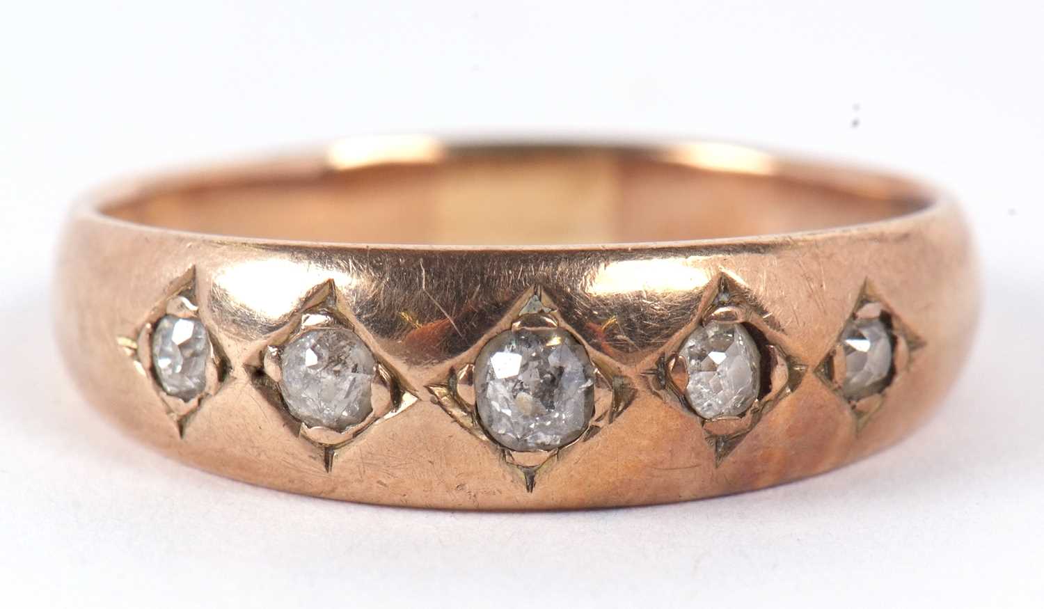 A five stone diamond ring, the five old mine cut diamonds, gypsy set to a plain band of unmarked - Image 2 of 7