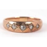 A five stone diamond ring, the five old mine cut diamonds, gypsy set to a plain band of unmarked
