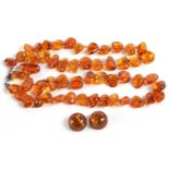 A modern amber necklace, a single row of mishapen polished beads together with a pair of cabochon