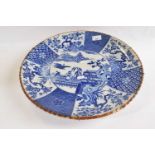 A large Japanese porcelain charger Meiji period decorated with blue and white decoration of