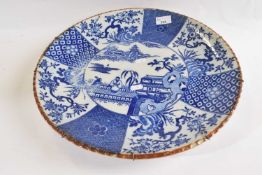 A large Japanese porcelain charger Meiji period decorated with blue and white decoration of