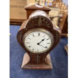 A Art Nouveau style mantel clock with brass inlay