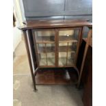 A late 19th Century mahogany display cabinet in the Art Nouveau style with two glazed doors over a