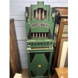 Rowe, New York, USA, a vintage cigarette dispensing machine in floor standing green and black