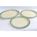 A graduated set of three Clarice Cliff bizarre serving dishes of ribbed form with green mottled