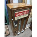 A vintage Woodbine wall mounted cigarette dispenser, 67cm high