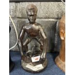 Carved African wooden figure of a drummer, 28cm high