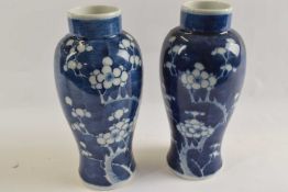 A pair of Chinese porcelain vases, the blue ground with prunus decoration, 22cm highgood condition