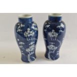 A pair of Chinese porcelain vases, the blue ground with prunus decoration, 22cm highgood condition