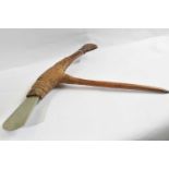 A Papua New Guinea stone bladed axe, with polished green stone blade, woven vegetal bindings and