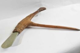 A Papua New Guinea stone bladed axe, with polished green stone blade, woven vegetal bindings and