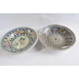 A pair of delft style bowls with polychrome floral decoration, 23cm diameter
