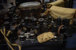 A large quantity mainly WWII binoculars, various makers and magnification including Kershaw, 1942