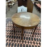 A Sheraton style circular centre table, the top with segmented satinwood veneered decoration, raised