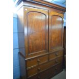 A large Victorian mahogany linen press cabinet with moulded cornice top section over two panelled