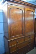A large Victorian mahogany linen press cabinet with moulded cornice top section over two panelled