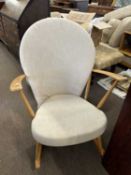 A Ercol stick back rocking chair with solid seat and loose cushions