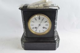 A late 19th Century black slate mantel clock with pendulum