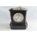 A late 19th Century black slate mantel clock with pendulum