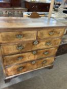 An 18th Century walnut chest of two short over three long drawers raised on bracket feet