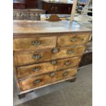 An 18th Century walnut chest of two short over three long drawers raised on bracket feet