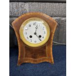 An Edwardian mantel clock of Waisted form, white dial with black numerals