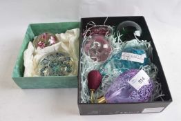 Two boxes containing a quantity of glass paperweights