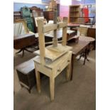 A vintage linen press cabinet with central screw thread over a single drawer raised on tapering