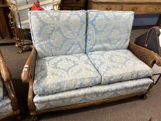 Late 19th or early 20th Century Bergere three piece suite comprising of two seater sofa and a pair