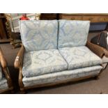 Late 19th or early 20th Century Bergere three piece suite comprising of two seater sofa and a pair