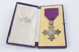 Silver British Empire medal (MBE) London 1928 on purple ribbon with original Garrard & Co fitted