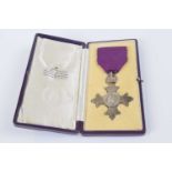 Silver British Empire medal (MBE) London 1928 on purple ribbon with original Garrard & Co fitted