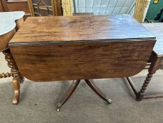 A 19th Century mahogany pedestal Pembroke table raised on four outswept legs with end caps and