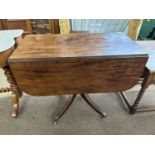 A 19th Century mahogany pedestal Pembroke table raised on four outswept legs with end caps and