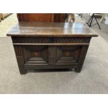 A 17th Century oak coffer reputedly of Flemish origin with two plank lid over a base with two