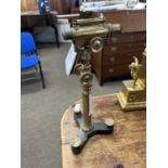 A antique brass adjustable level or microscope, raised on a tripod base, 44cm high
