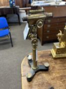 A antique brass adjustable level or microscope, raised on a tripod base, 44cm high