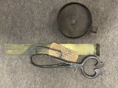 Plastic bag containing a mixed lot including a brass fish rule, tinder box, antique steel sugar nips