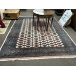 A 20th Century Bokhara type machine made floor rug, 305 x 252cm