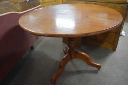 A 19th Century cherry pedestal supper table with circular top raised on turned column with tripod